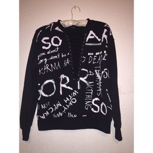 It’s a black sweater with white lettering